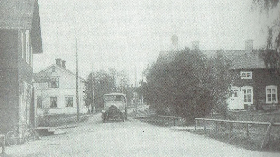 En bild av Porsnäsvägen från början av 1920-talet. Den vita gården, sedan ett antal år tillbaka riven, var under många år privathotell. I förgrunden, till vänster, ses J A Sandlunds diversehandel.