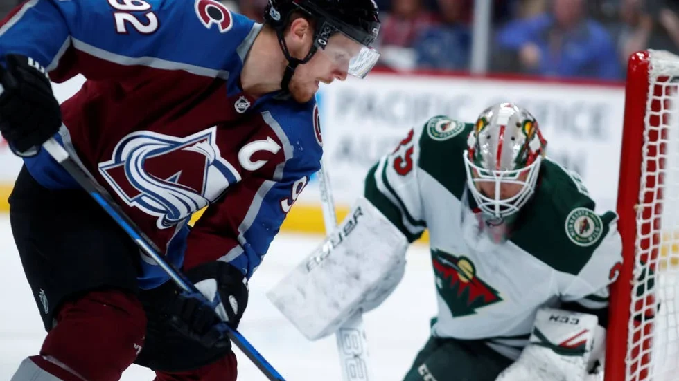 Colorado Avalanche left wing Gabriel Landeskog, front, of Sweden, redirects the puck at Minnesota Wild goalie Niklas Svedberg in the first period of a preseason hockey game, Sunday, Sept. 24, 2017, in Denver. (AP Photo/David Zalubowski)