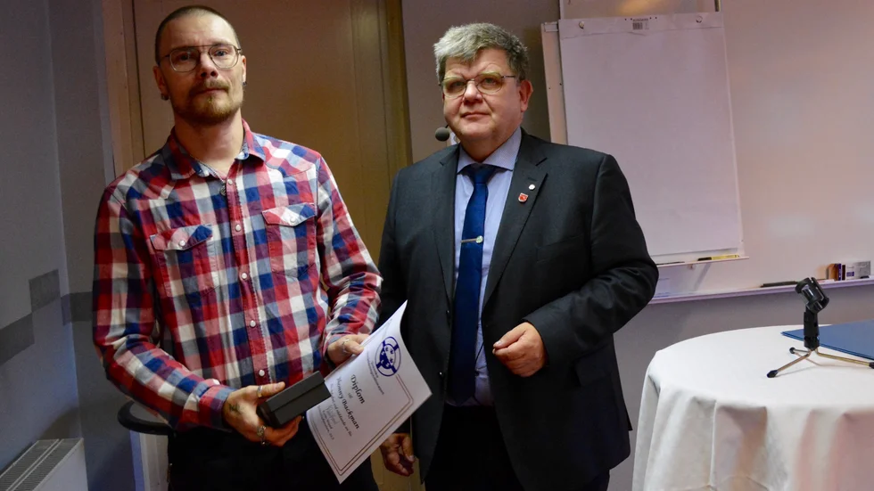Jhonny Backman tog emot utmärkelsen av kommunfullmäktiges ordförande Joacim Eliasson.