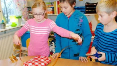 Grytgölseleverna Hanna Johansson, Linus Andersson och Erik Joelsson slår in julklappar till de fattiga barnen.