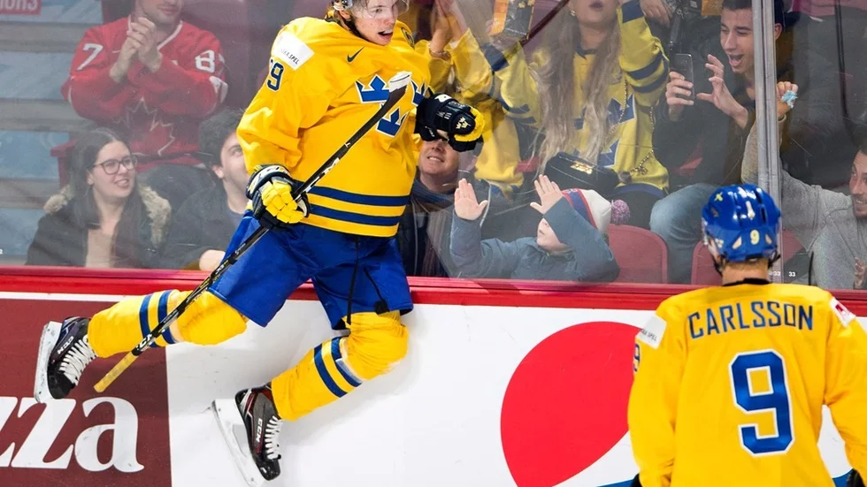 Sweden's Tim Soderlund (29) celebrates after scoring the team's sixth goal as teammate Gabriel Carlsson (9) looks on during the third period of a world junior championship hockey game in Montreal, Monday, Jan. 2, 2017. (Ryan Remiorz/The Canadian Press via AP)