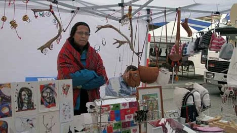 Det samiska inslaget är inte stort på sommarmarknaden, men det finns. Här är det Ann-Ristin Fjällgren, med sin man, något skymd, som saluför samiskt konsthantverk.