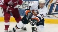 New York Islanders' Janne Niinimaa (44), of Finland, reaches for a loose puck while being shadowed by Detroit Red Wings defender Tomas Holmstrom (96), of Sweden, during the third period on Sunday evening, Dec. 4, 2005 in Detroit. The Islanders won 2-1. (AP Photo/Jerry S. Mendoza)  COPYRIGHT SCANPIX SWEDEN Code: 436