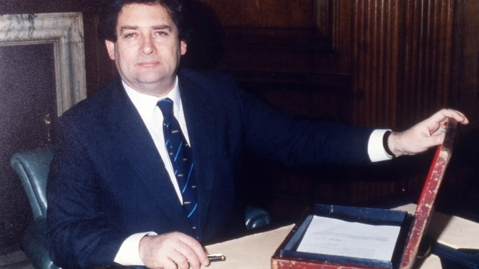 Nigel Lawson och "budgetlådan". Den användes vid den brittiska motsvarigheten till Sveriges budgetpromenad, då finansministern tar sitt budgetförslag till parlamentet. Bilden är från våren 1987.
