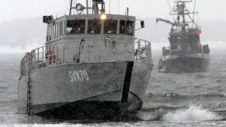 Dras flott. Nästan uppe på stranden ligger SVK Hojskär och i bakgrunden kämpar HMS Djärv tills trossen brister.
