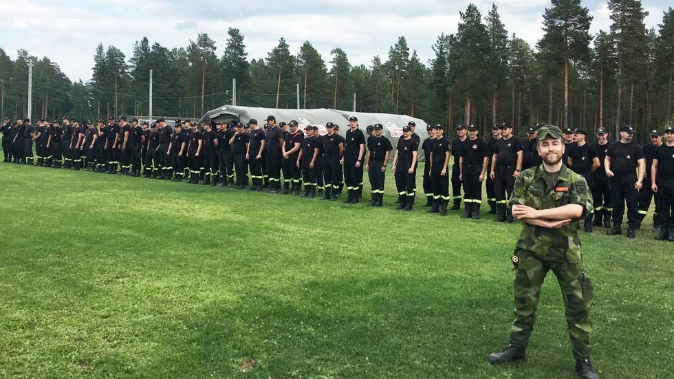 De polska brandmännen står uppställda bakom Niklas Björkegren i Sveg, där de bekämpade skogsbränder i somras.