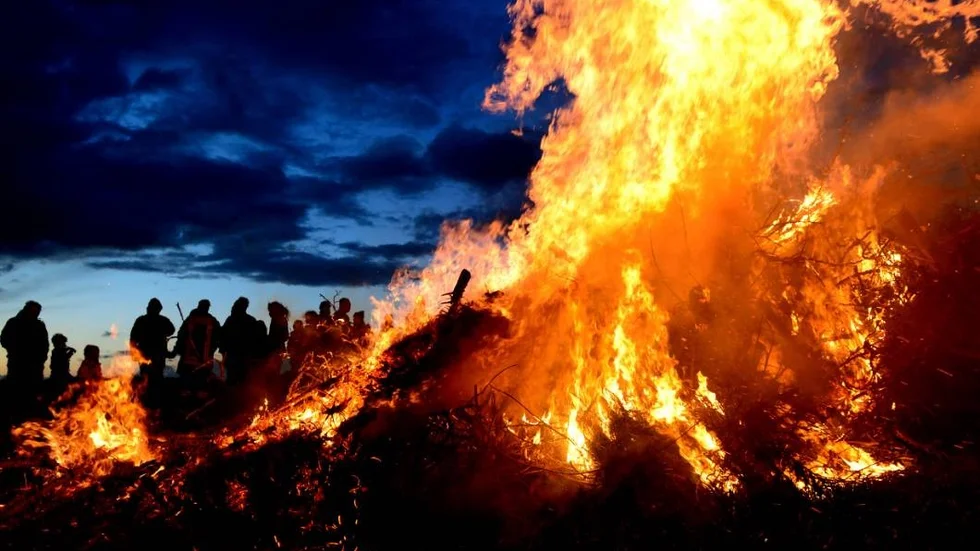 In this April 15, 2017 photo spectators watch the traditional Easter bonfire in Wartjenstedt, Germany. (Maurizio Gambarini/dpa via AP)