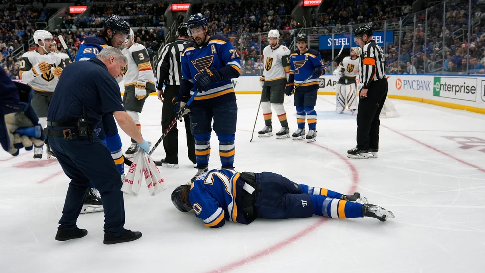 Oskar Sundqvist blev liggande i svåra smärtor och fick hjälpas av lagkamrater i St Louis för att ta sig av isen.