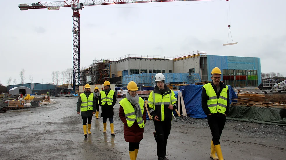 Till höger om konstnären Mårten Medbo syns några av kollegan Josefine Lyches glaspartier monterade. Nina Halden Rönnlund, kulturchef, och Emil Uleander, projektchef Cobab längst fram i bild.