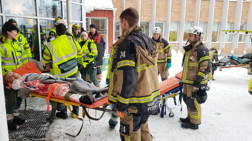 Ambulanspersonal samarbetade med räddningstjänsten med att föra ut skadade till väntande ambulanser. 