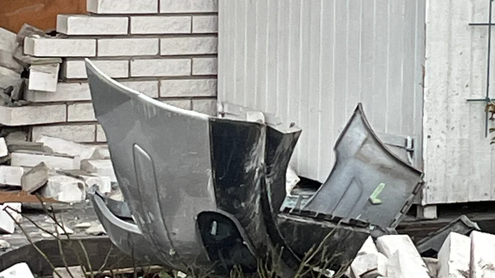 Den främre delen av bilen ligger på hustomten.
