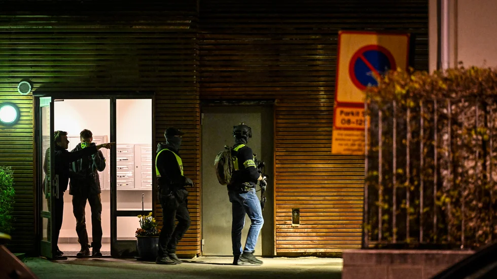 Poliser på plats efter larm om en skjutning mot en lägenhet i Hammarby sjöstad i södra Stockholm på fredagskvällen.