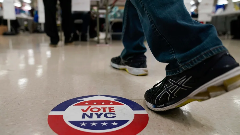 Ett klistermärke på golvet i en vallokal i New York visar vägen. Arkivbild från 2021.