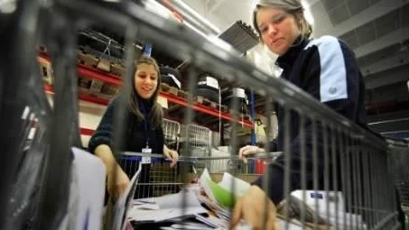 Just nu är det full fart Posten i Västervik. Tolv personer, de flesta skolungdomar, har extraanställts för att hantera störtfloden av julkort till och från Västervik. Här sorterar Rebecka Fredriksson, till vänster, och Anna Nilsson kort, brev och paket.Foto: Anders Steiner