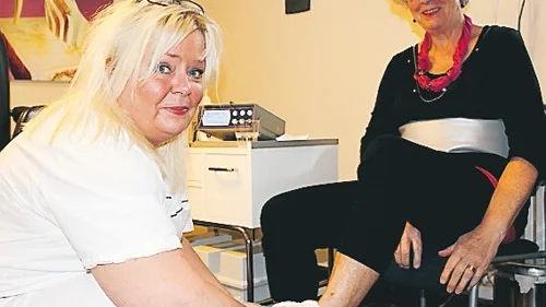 Ann-Sofie Carmé torkar av fötterna på Gun-Britt Dovnäs efter en ldetoxkur.