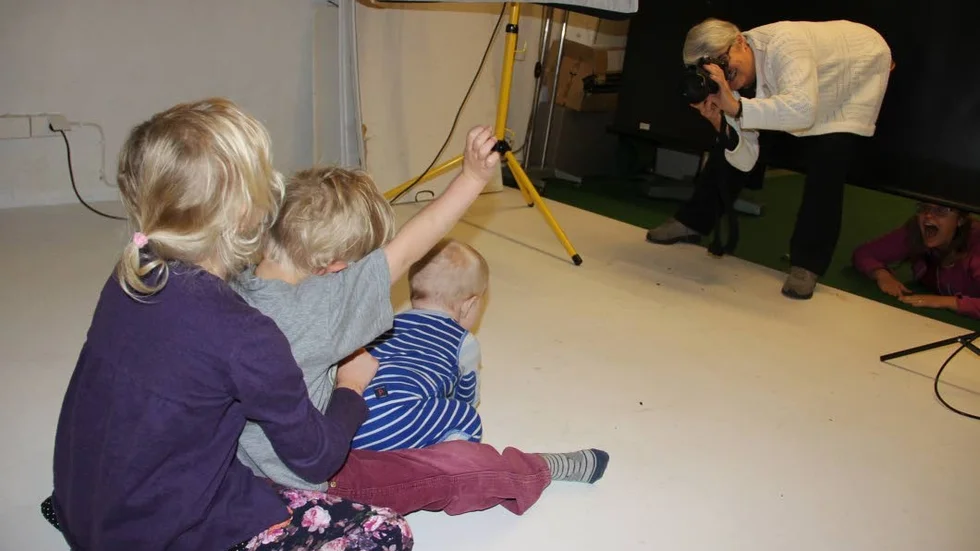 Megafoto. Gunilla Lundqvist, sekreterare i Söderfors Fotoklubb, fotograferar barnen Idun, Ejvind och Adil Wisell i klubbens studio.
