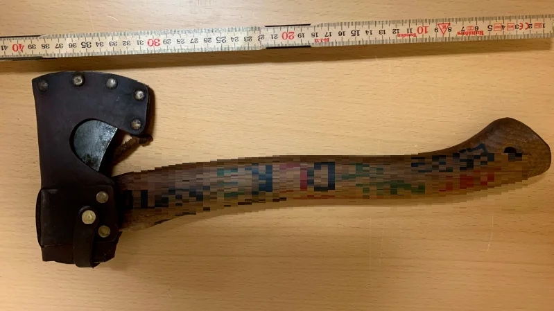 Den här yxan använde sig mannen av. På skaftet är skrivet flera ord, bland annat en del av hans namn.