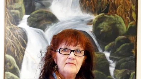 Allkonstnären Birgit Långdahl Löf vid sin målning "Höstbäcken".