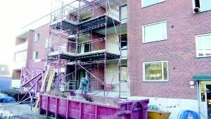 Foto: HANS BRANDIN En byggarbetare står på Siv Johansson balkong på Åbyhöjden. Det är hål rakt in i väggen till lägenheten. På andra sidan entrén ligger makarna Svenssons balkong. När de återvänder i juni nästa år har de ytterligare en balkong att sola sig på, en balkong som vätter mot Gamleby centrum.