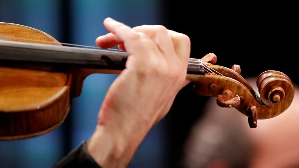 A violin is played during a classical music performance at SoundBox on Friday, April 10, 2015, in San Francisco. With an average audience age over 60, the San Francisco Symphony wanted to reach a younger audience for classical music. They created a new high-tech venue that looks like a Vegas nightclub, until the music starts. (AP Photo/Marcio Jose Sanchez)
