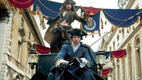 FLYKT MED FLYT. Kapten Jack Sparrow (Johnny Depp) flyr från kung George och hans trupper genom att hoppa från vagn till vagn. Medan de rullar ...
