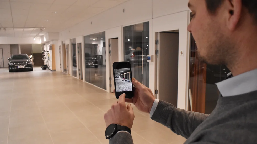 Erik Eriksson visar upp bilder från tidigare i byggprocessen. "Vi fick jobba med hörselskydd på", säger han.