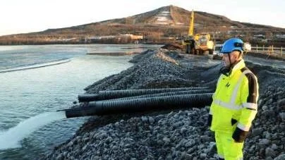 Dammen är klar och tömningen av Luossajärvi har inletts. Tjabba Nordanfjäll, projektledare vid LKAB, ser vattnet forsa ut med en hastighet av 330 liter i sekunden.<_Bildtext Fotobyline>FOTO: Hans Sternlund</_Bildtext Fotobyline>