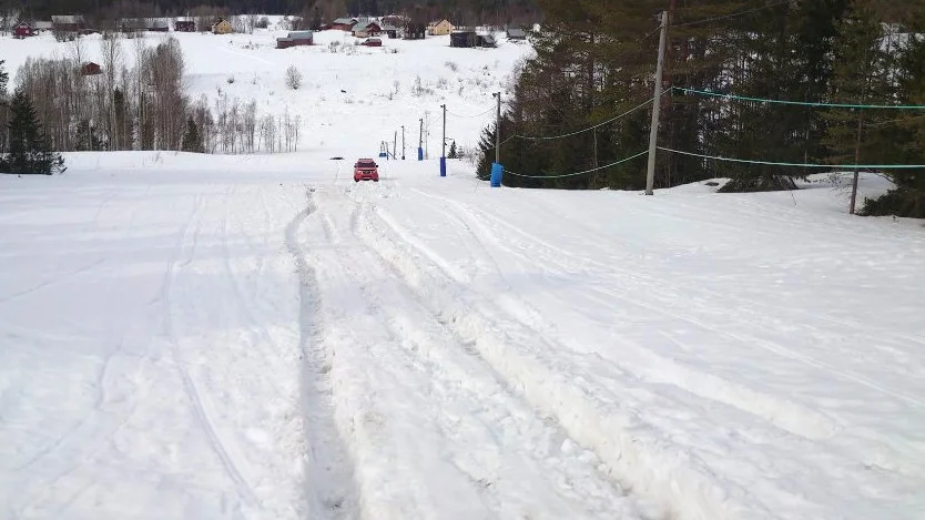 The car caused damage to the hill and there were clear wheel tracks in the snow. The red vehicle in the picture is one of the tow trucks used to recover the car.