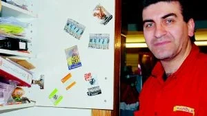 Det är inte första gången Nabil Afrim, som driver Handlarn i Sonstorp, utsätts för hot. Här visar han klistermärken med nazistiska symboler, som klistrades upp på affären för några månader sedan. Foto: Malin Perk