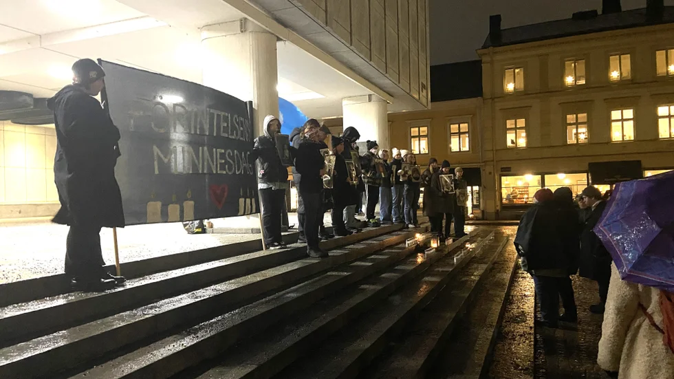 En tapper skara i busvädret uppmärksammade Förintelsens minnesdag på stadshustrappan.