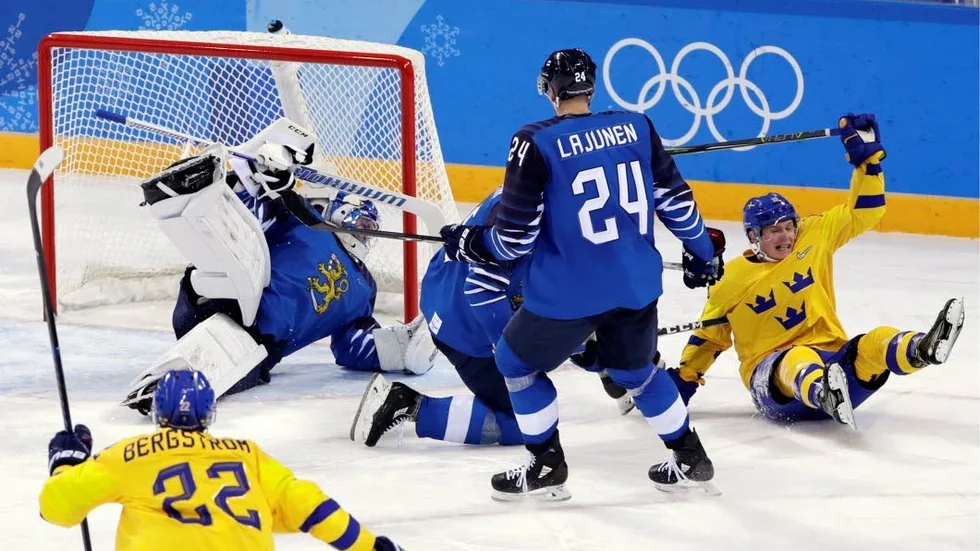 Patrik Zackrisson, of Sweden, right, celebrates after scoring a goal as goalie Mikko Koskinen, of Finland, left, reacts during the third period of the preliminary round of the men's hockey game at the 2018 Winter Olympics in Gangneung, South Korea, Sunday, Feb. 18, 2018. Sweden won 3-1. (AP Photo/Frank Franklin II)