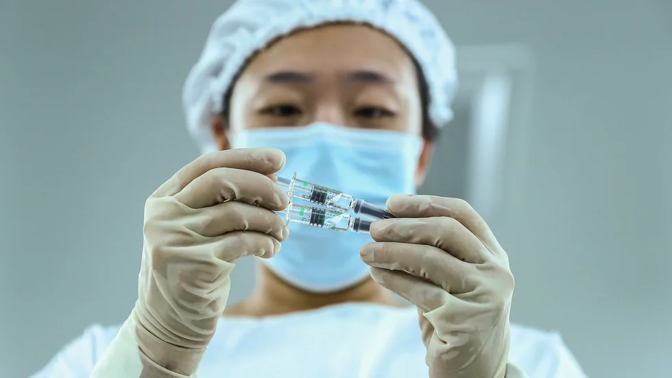 Vaccinampuller inspekteras vid en anläggning tillhörande ett dotterföretag till Sinopharm.
