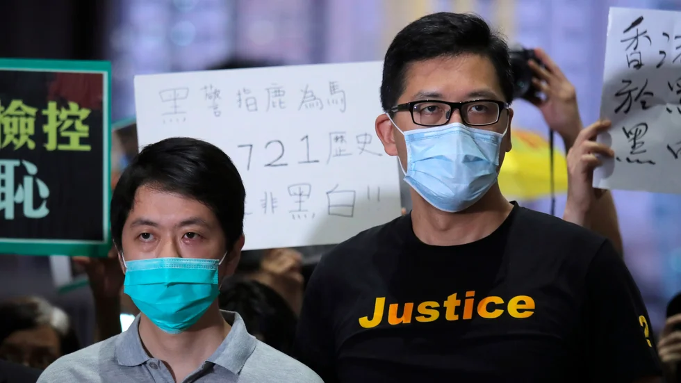 Demokratiförespråkarna Ted Hui (till vänster) och Lam Cheuk-Ting sedan de släppt mot borgen i Hongkong i augusti. De misstänks för brott med anknytning till regimkritisk verksamhet. Arkivbild.