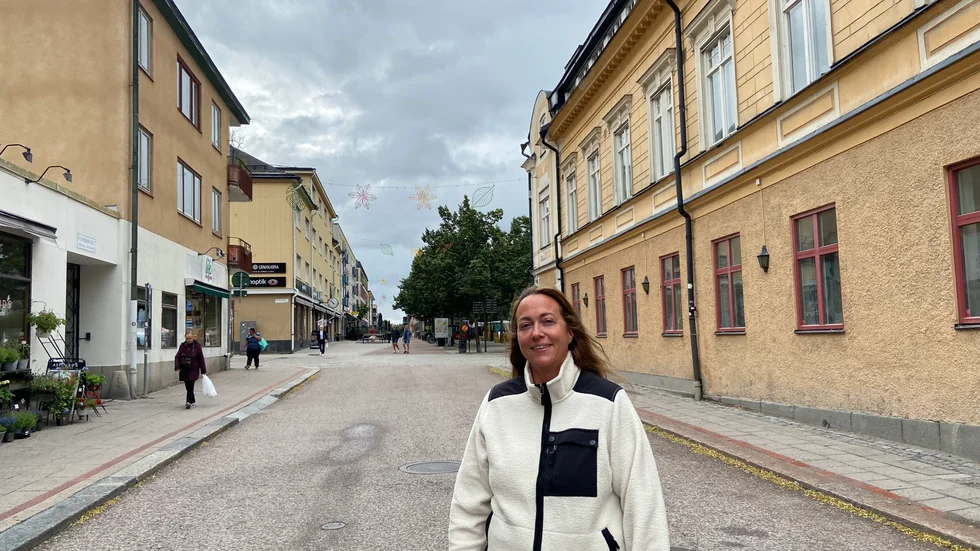 Sara Karlsson Olsson visar prydnaderna som hänger över gatorna och ska visa vägen till centrum.