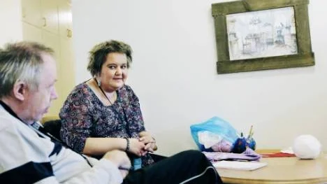 Anna Wiklund är halvtidsanställd och förlorar sin sysselsättning om Träffpunkten stängs. I förgrunden ser vi en av gästerna, Ove Karlsson, som är bedrövad över stängningsplanerna.