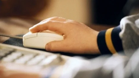 Child Using Computer Mouse --- Image by © Rob Goldman/Corbis