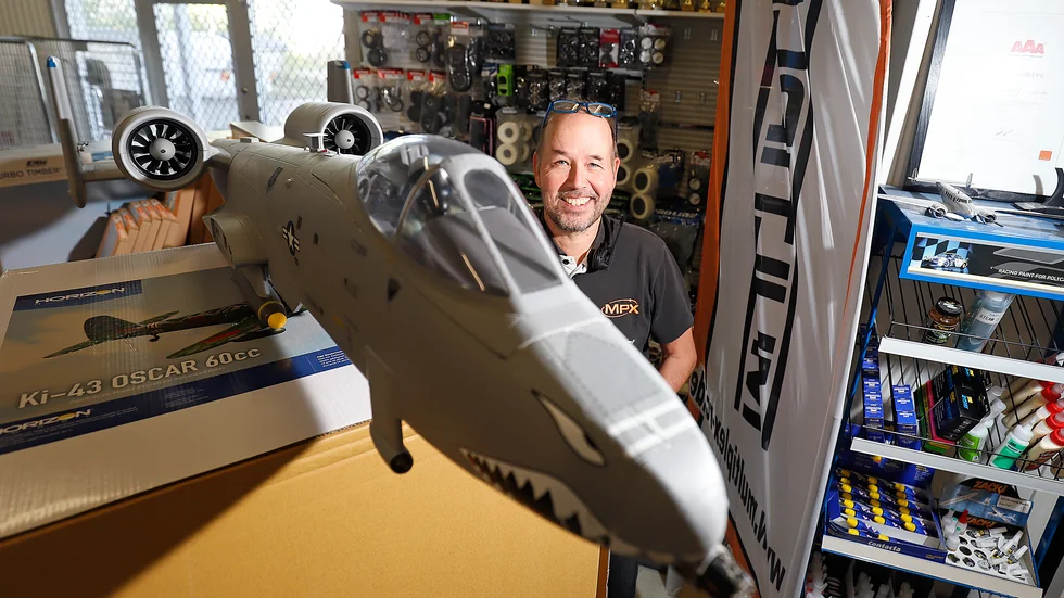 Per Vässmar, på familjeföretaget Autopartner i Torshälla, tar skydd bakom en modell av det ikoniska amerikanska attackplanet A-10 Warthog.