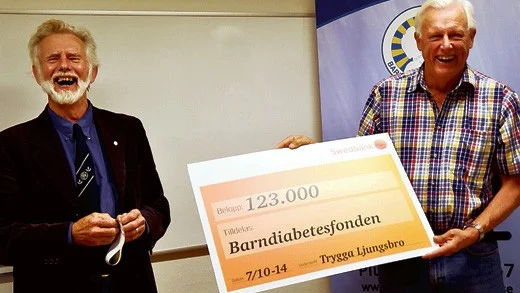 En glad Göran Ingvald får en stor check av Johnny Ludvigsson.