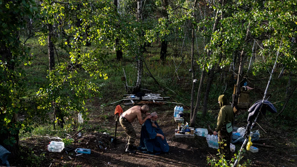 Ukrainska soldater klipper håret på varandra i den återtagna staden Lyman den 3 oktober.