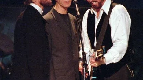 **FILE**The Bee Gees, from left, Maurice, Robin and Barry Gibb sing together in their first U.S. performance in five years, at the MGM Grand in Las Vegas, on Nov. 14, 1997.  The University of Manchester said Monday it us awarding honorary degrees to Robin and Barry Gibb of the Bee Gees, as well as a posthumous honor for their brother Maurice.  The awards will be presented to the two Gibb brothers during a ceremony at the university on Wednesday. They will also accept a degree for their brother, who died in January 2003, from Chancellor Anna Ford. (AP Photo/Jack Dempsey,file)