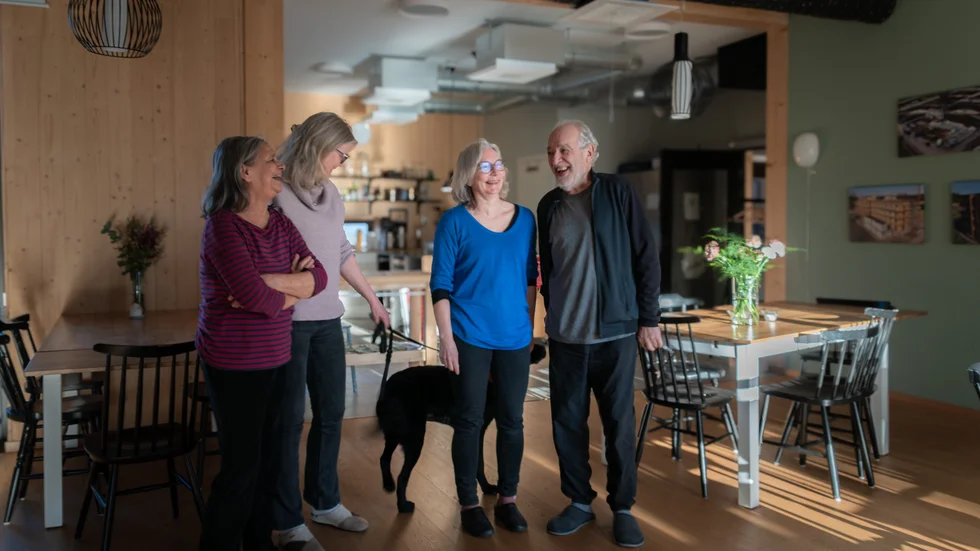 Alejandra Mujica Toro, Maria Lindström Nilsson, Torun Liljeholm Baroudi och Carlos Zanzi i ett av Gårdens gemensamma rum. Hunden heter Indy och är en jaktlabrador.