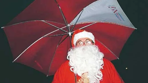 Tomten fick ta till paraply för att freda sig mot regnet under  julkalaset i Ingatorp.