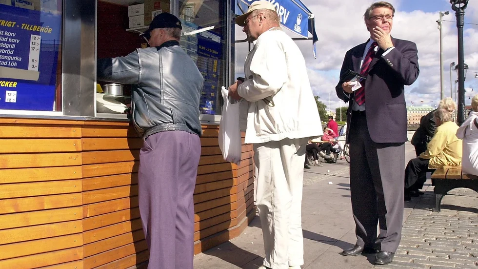 Dåvarande moderatledaren Bo Lundgren äter en snabb lunch bestående av varmkorv och glass på Mynttorget i Stockholm under valrörelsen 2002.