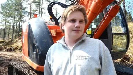 Victor Larsson, Hummelstad, framför sin "skolbänk" - han tillbringar mesta delen av skoltiden i grävmaskinen. Foto: Hans Brandin