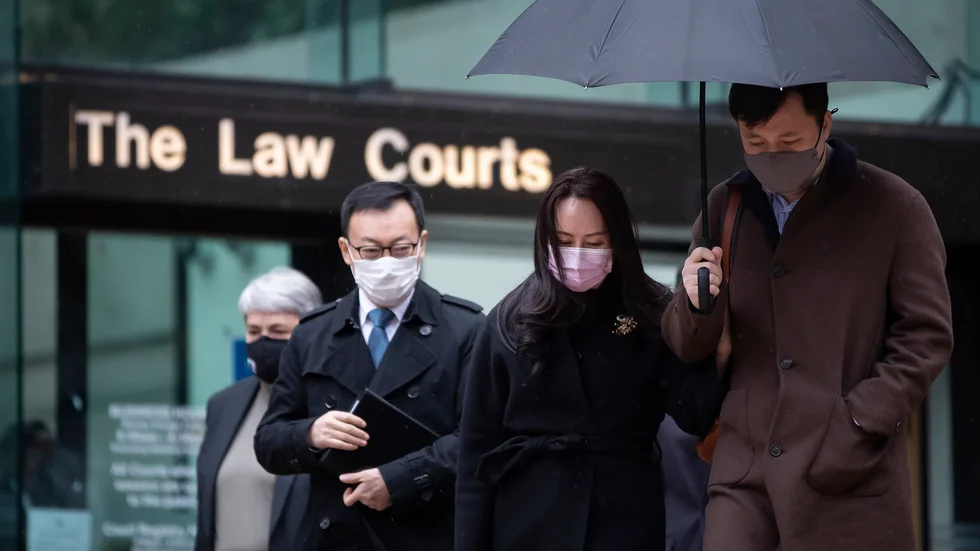 Huaweis finanschef Meng Wanzhou och hennes man Liu Xiaozong (til höger i bild)