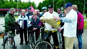 Verner Bilde i Skärblacka PRO läser budskapet i budkavlen. Paraplyförsedde Gustav Heijdenberg i PRO Finspång är redo att ta emot budkavlen och föra den vidare till Östra Eneby PRO.
FOTO: TITTI OLOVSSON