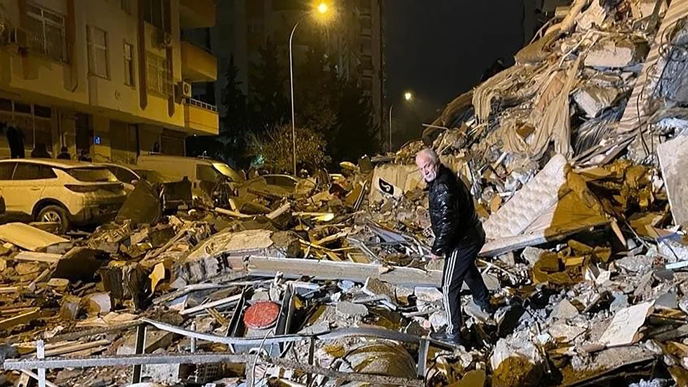 En man söker vid en byggnad som har kollapsat i Diyarbakir i södra Turkiet. Över 900 människor har dött av jordskalven bara i Turkiet.