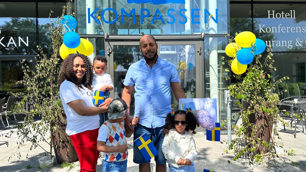 Familjen med mamma Yeibyo Kahsay och pappa Daniel Tesfamariam utanför Kompassen med minnesbevis och svenska flaggor. Daniel och barnen fick nyligen svenskt medborgarskap.
