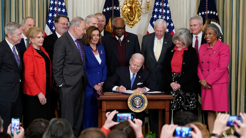 Nancy Pelosi (i blått) bredvid en sittande Joe Biden dagen innan det blev känt att hon har covid-19.