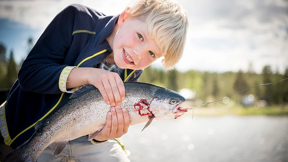 Eddie Nilsson, Boden, håller gärna upp den granna fisken som hans storasyster fått upp.